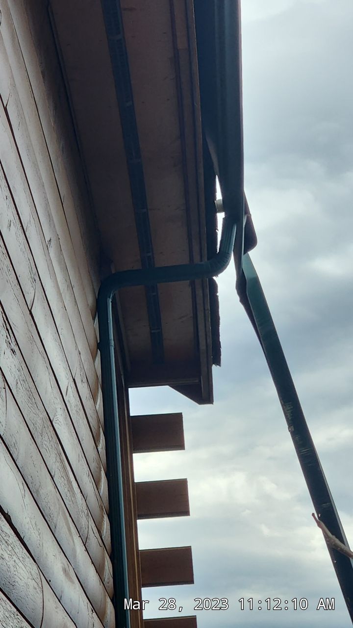 Bent, twisted gutter and damaged downspout