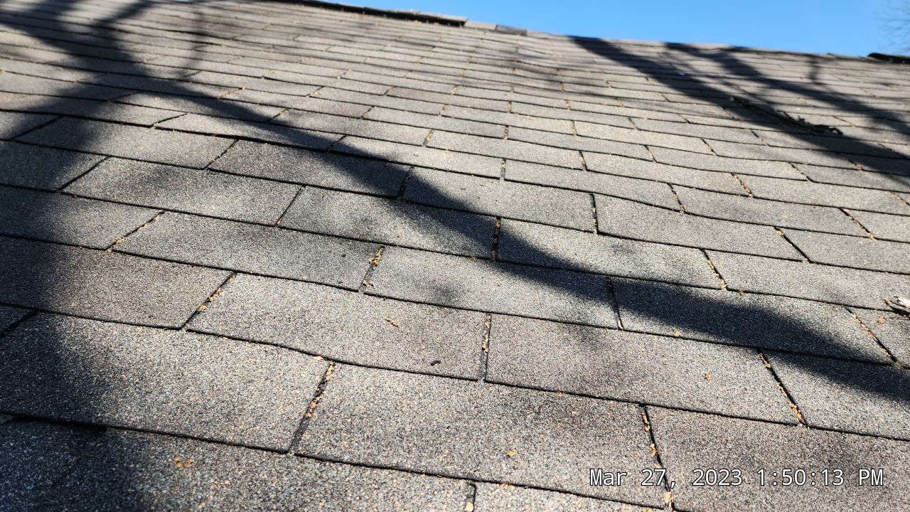 Warped shingles and sunken areas of the roof