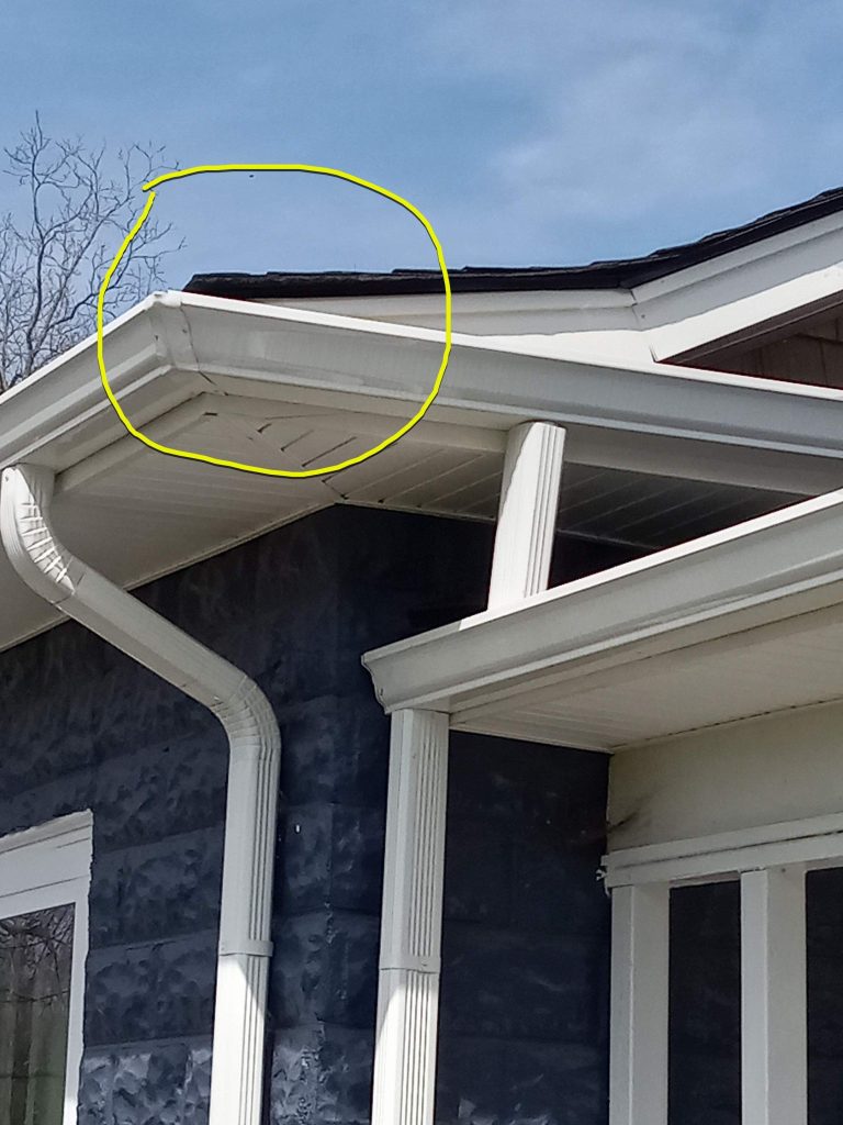 Slight upturn on shingles on corner. If facing front door of home, this is the front left corner.