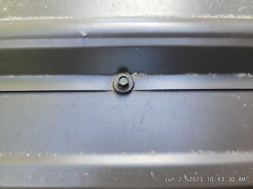 Loose, rotting screw at edge of panel