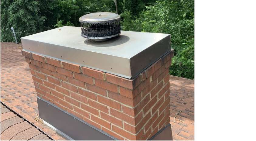 Photo of a chimney cap installed on a chimney.