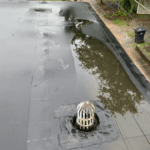flat commercial roof drainage, roofing maintenance Knoxville TN, commercial roof water pooling, roof ponding causes, EPDM roof ponding, how to fix flat roof ponding, water pooling on commercial roofs, commercial roof drainage system, flat roof design tips, commercial roof maintenance, roof water damage prevention, commercial building roofing solutions, flat roof slope standards, water pooling flat roof risks, Litespeed Construction Knoxville