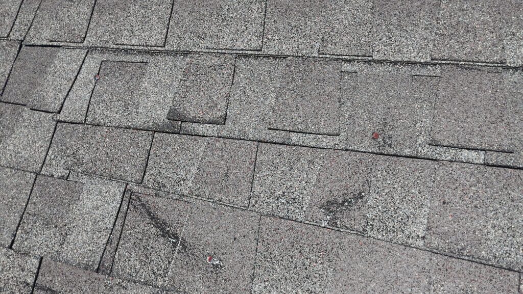 creased shingles, exposed nails, damaged roof shingles