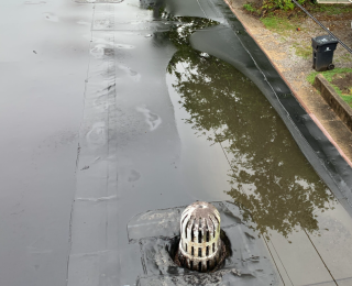 flat commercial roof drainage, roofing maintenance Knoxville TN, commercial roof water pooling, roof ponding causes, EPDM roof ponding, how to fix flat roof ponding, water pooling on commercial roofs, commercial roof drainage system, flat roof design tips, commercial roof maintenance, roof water damage prevention, commercial building roofing solutions, flat roof slope standards, water pooling flat roof risks, Litespeed Construction Knoxville